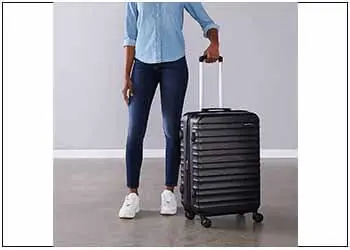 a woman carrying a Spinner luggage