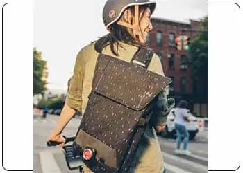 a woman carrying a sling bag on her back